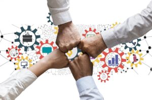 Four hands fist bumping with the CGP Digital Services logo in the background.